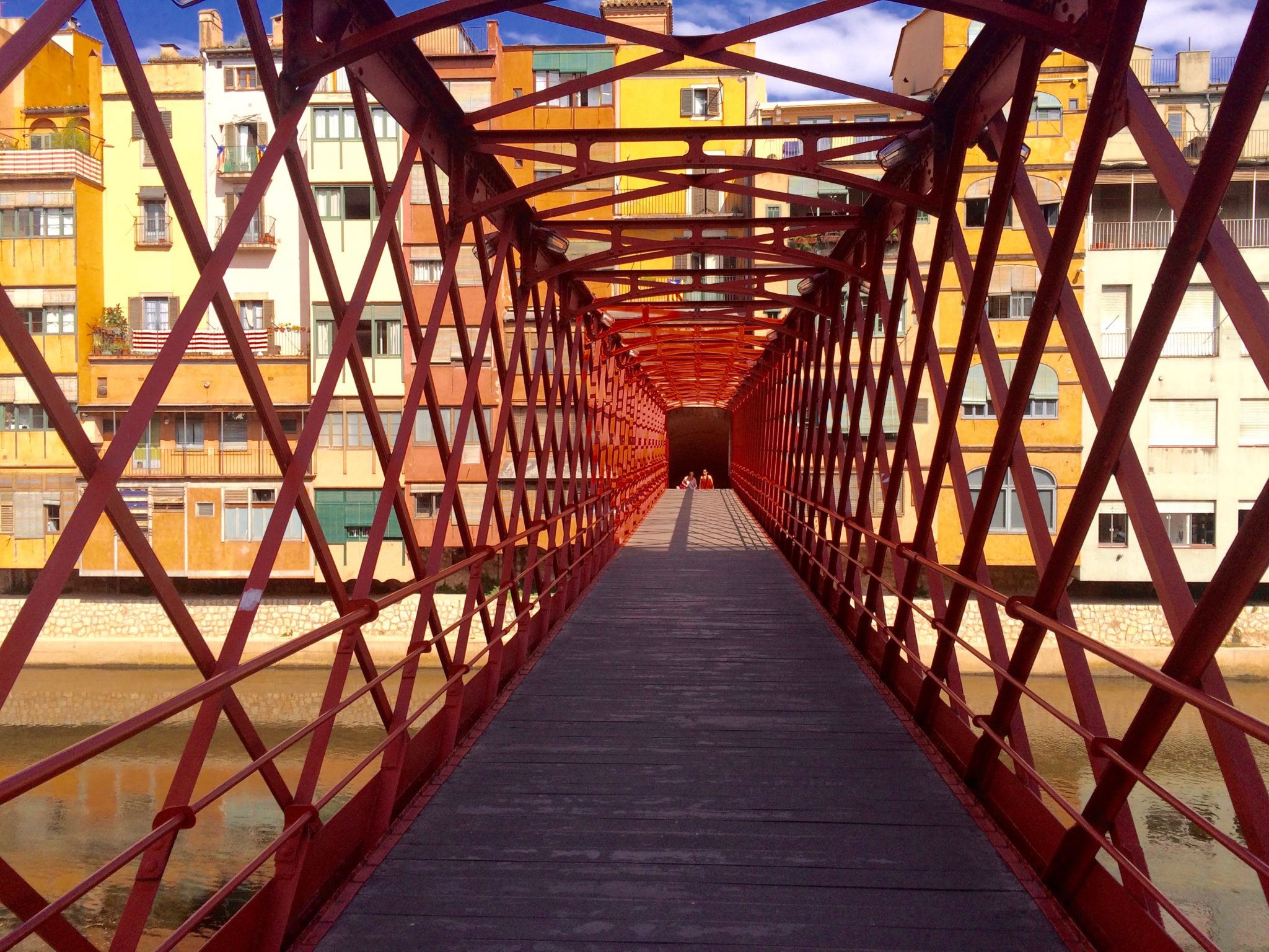 Red iron-and-lattice Eiffel Bridge over the Onyar River, Girona, Catalonia, Spain