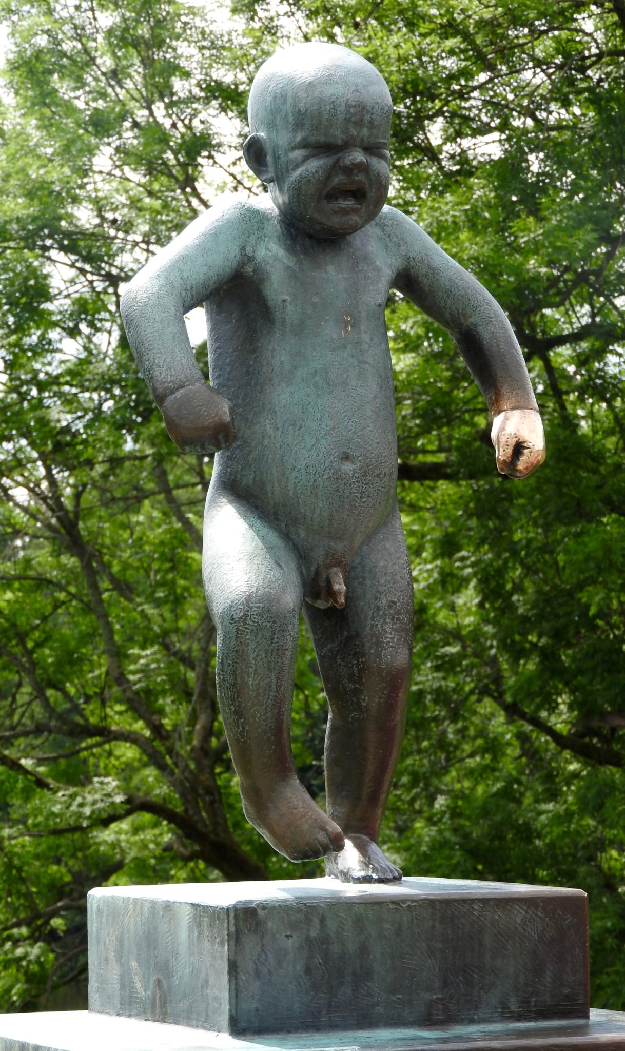 Bronze statue of a toddler throwing a tantrum