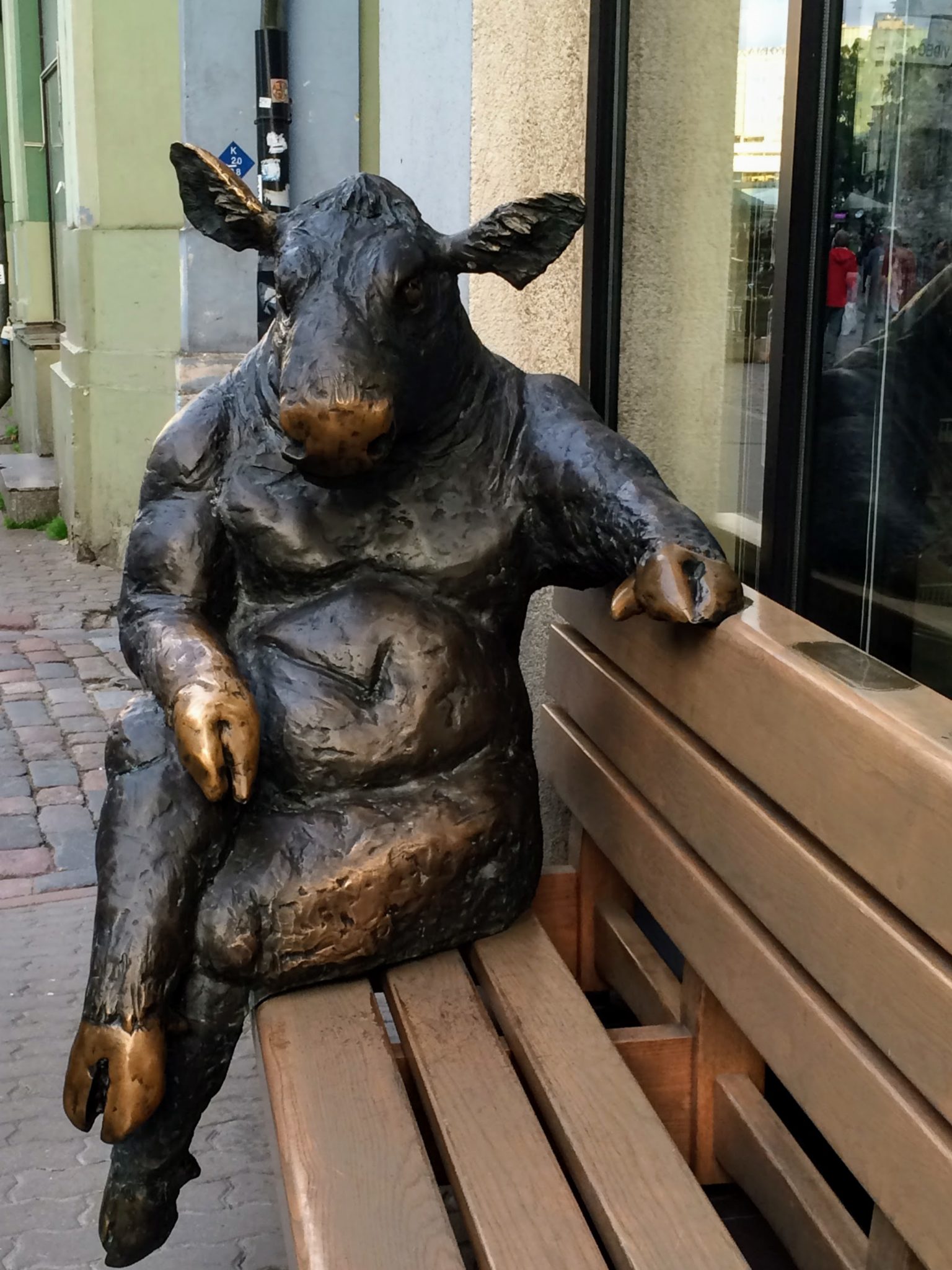 Bronze statue of a cow seated on a bench Tallinn, Estonia