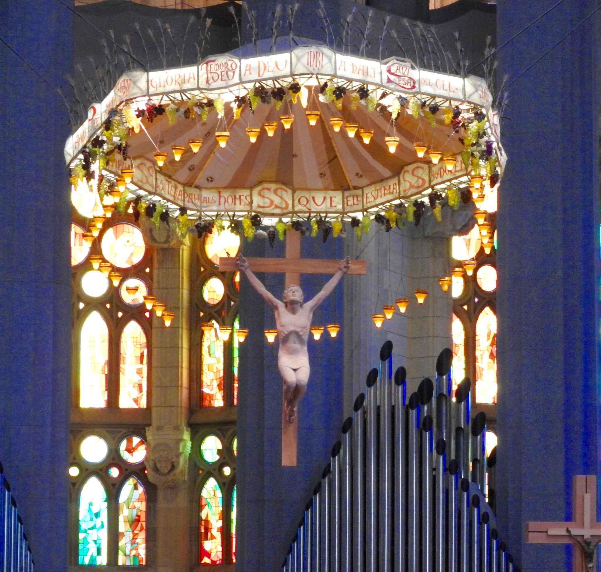 figure of a crucified Jesus, against stained glass church backdrop