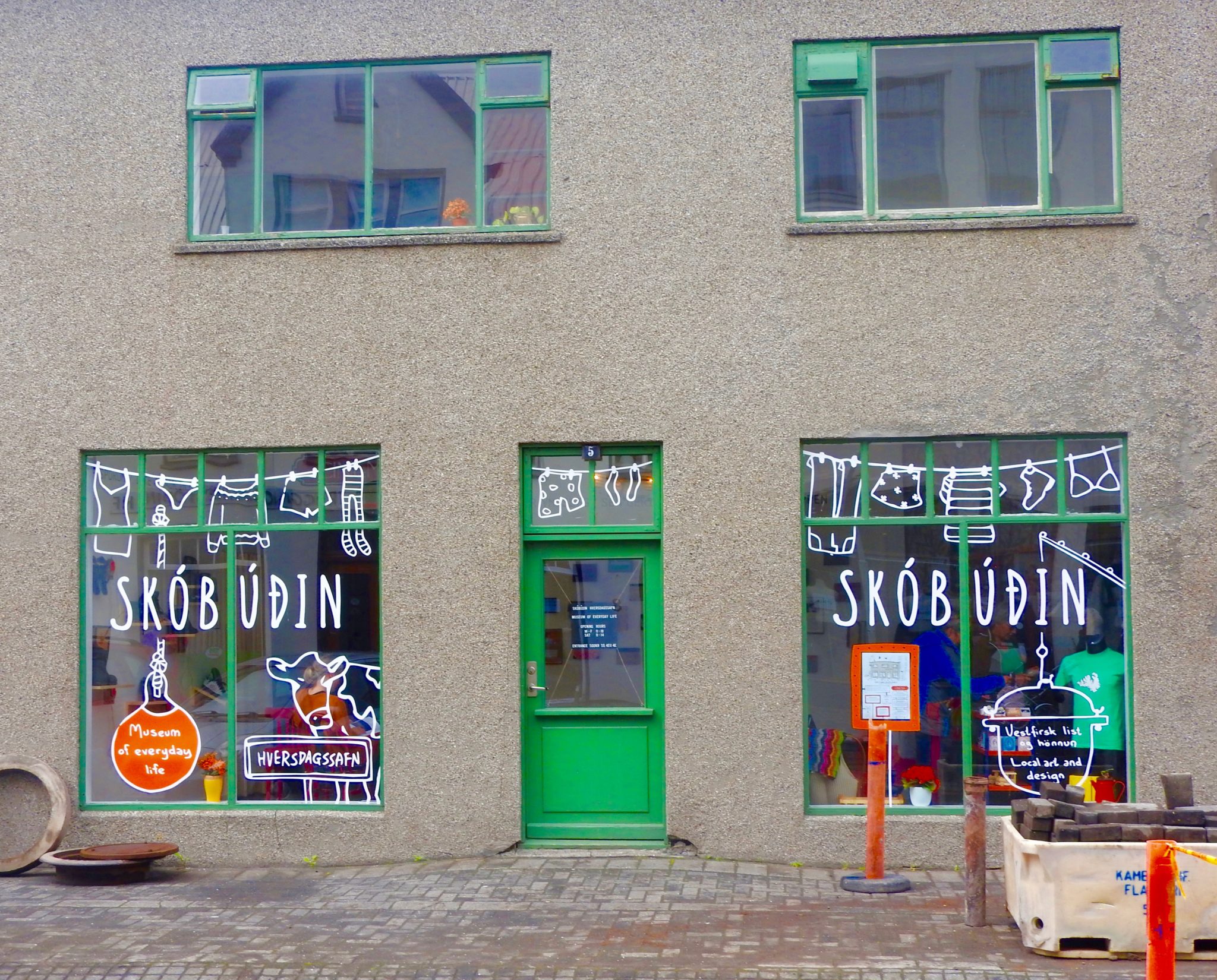 Grey building with green shutters