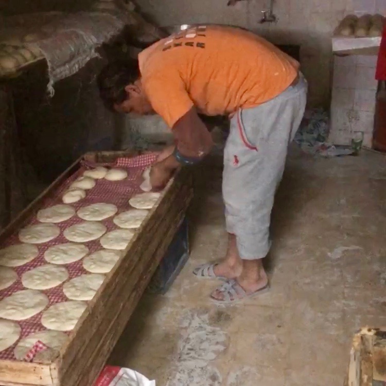 Baker prepping bread dough